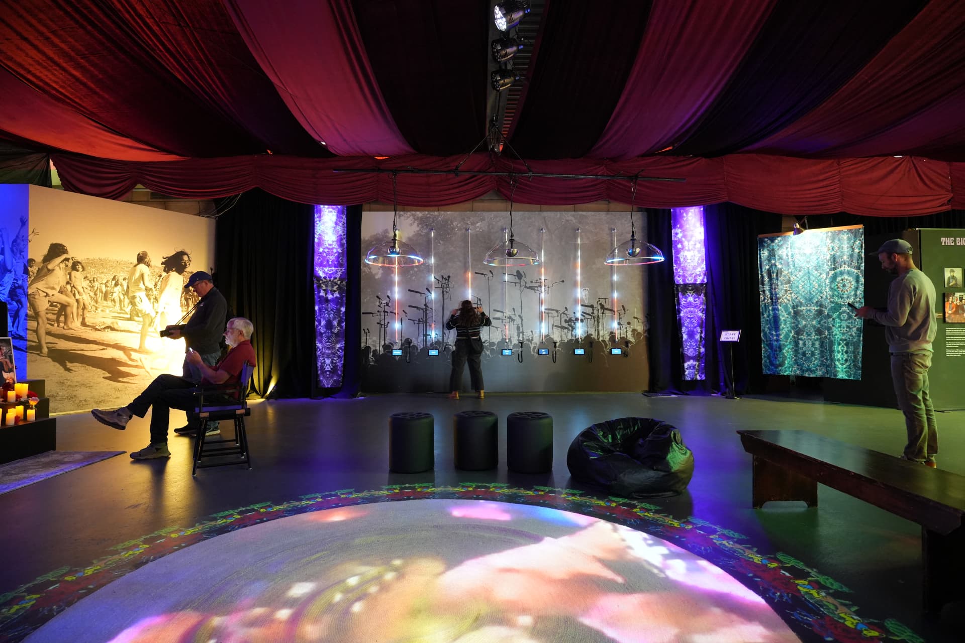 Guests watching projections across the main room of the exhibition