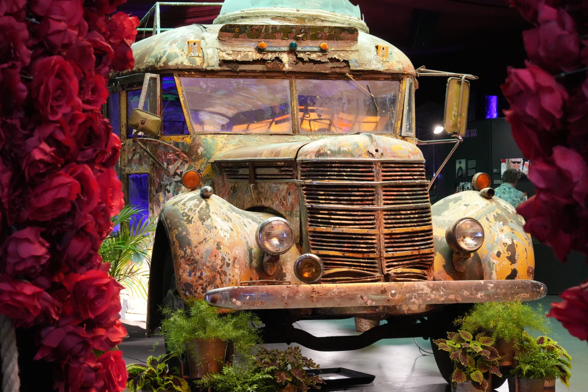 The Furthur bus framed in red roses inside the Forever Grateful exhibition