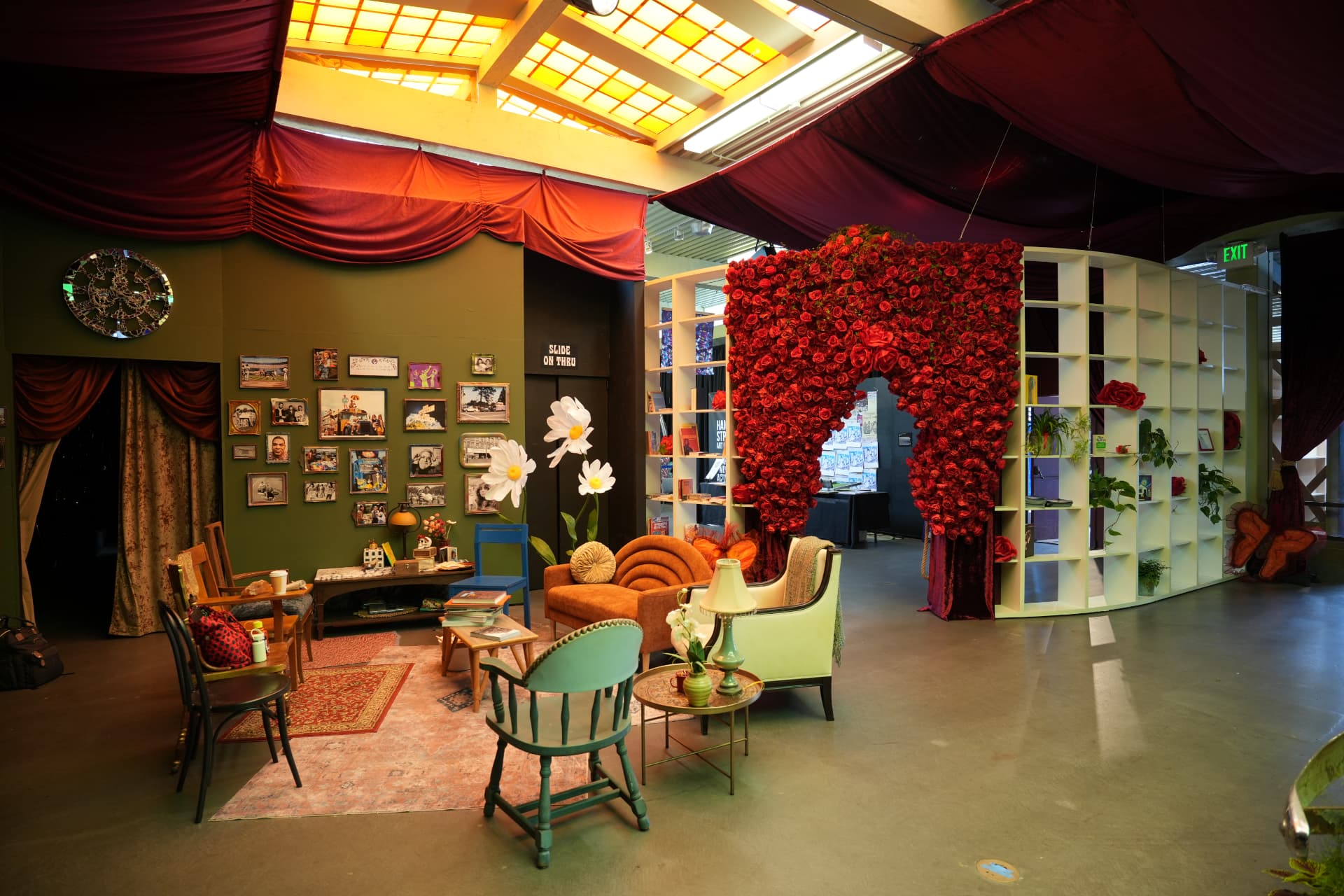 Reading room with rose-covered arch, photo wall, and gathered seating
