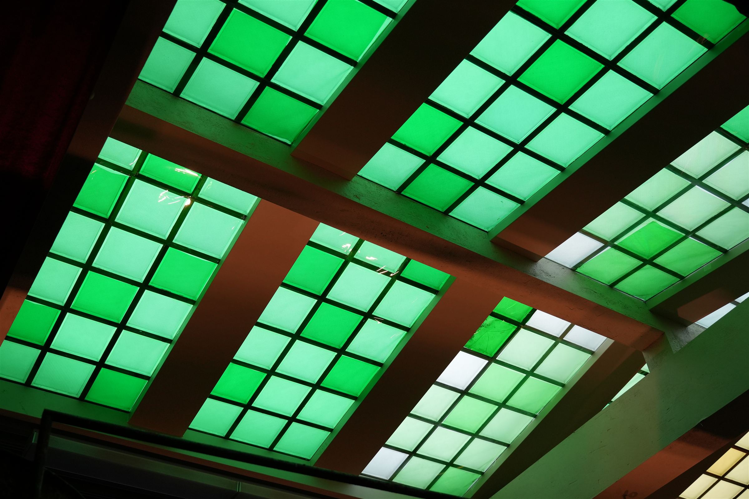 Gelled skylight windows glowing green and gold