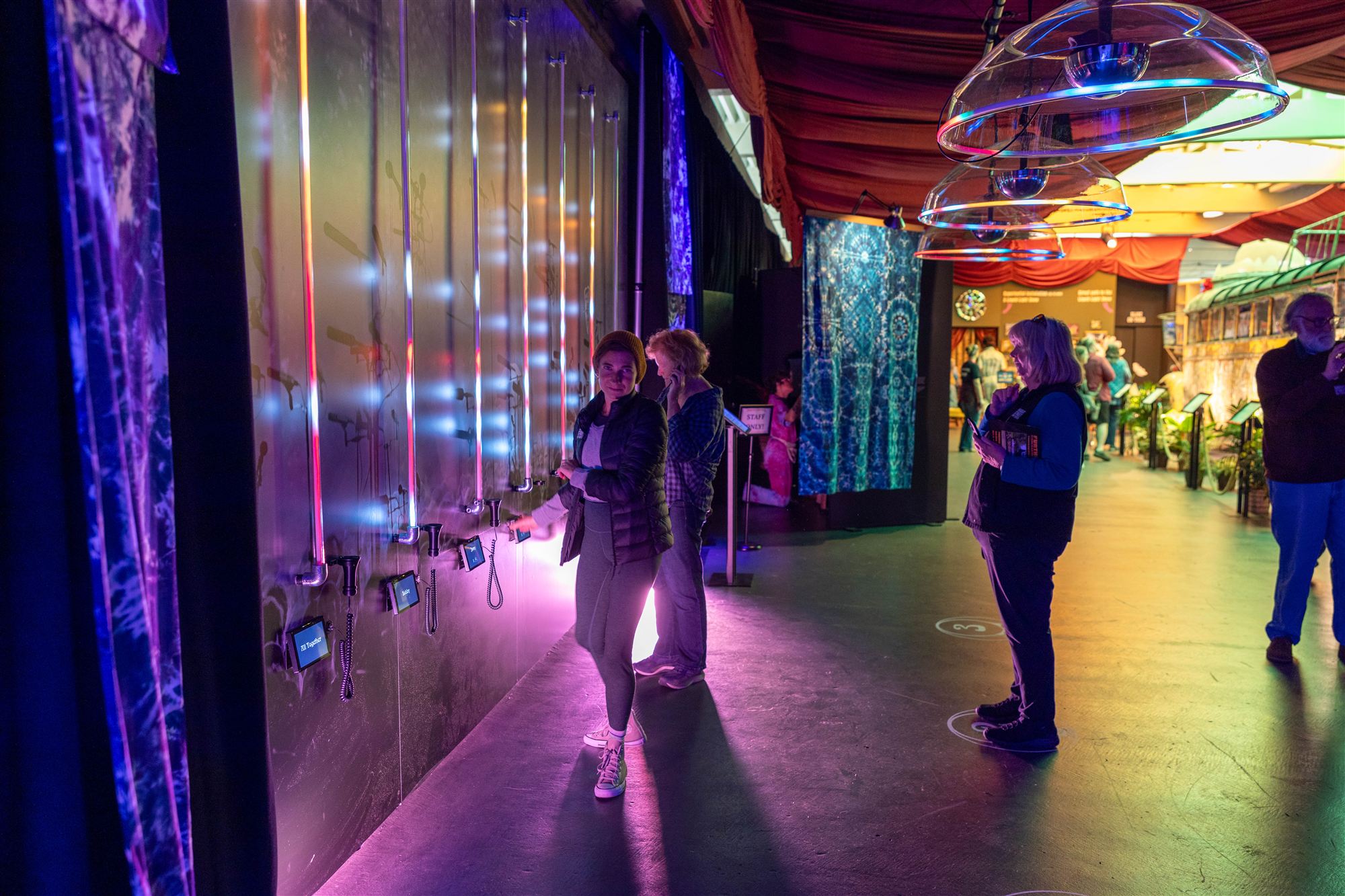 Guests among the tube fixtures of the Radical Listening Wall
